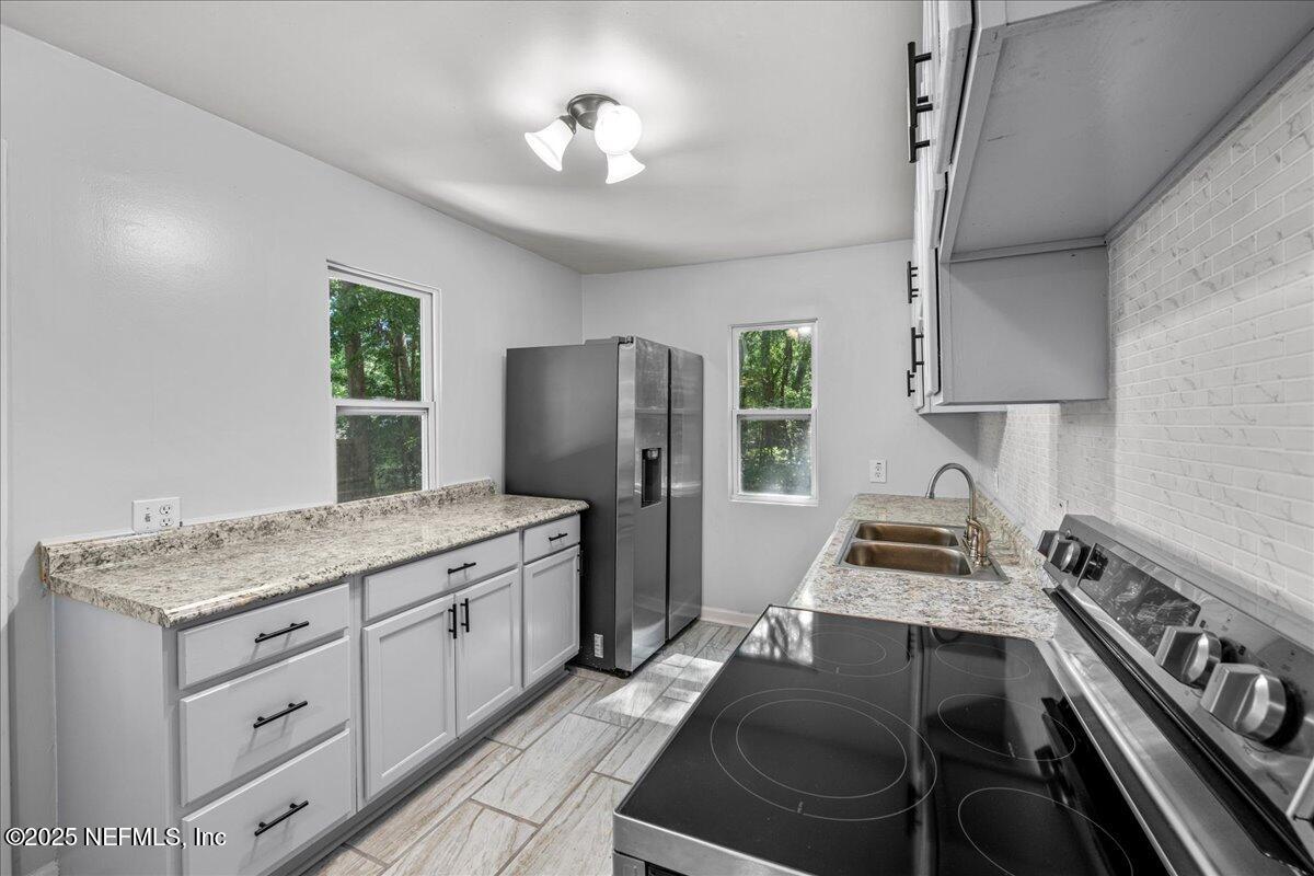 2059 Blair Road Jacksonville, FL 32221 - Photo 8 of 19 a kitchen with a stove and a refrigerator