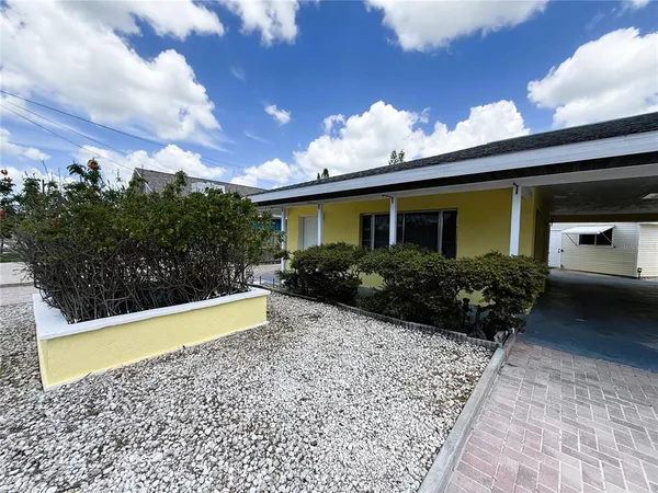 a view of a house with backyard and sitting area