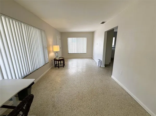 a view of a livingroom with furniture and a window