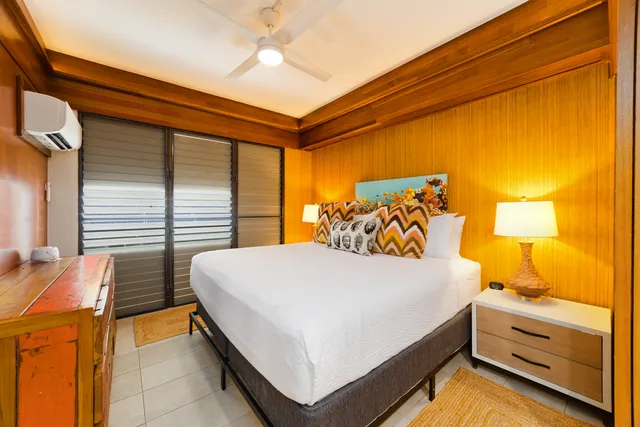 a bedroom with a bed and a night stand