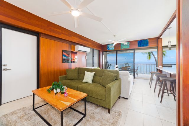 a living room with furniture a rug and a window