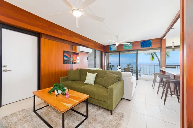 a living room with furniture a rug and a window