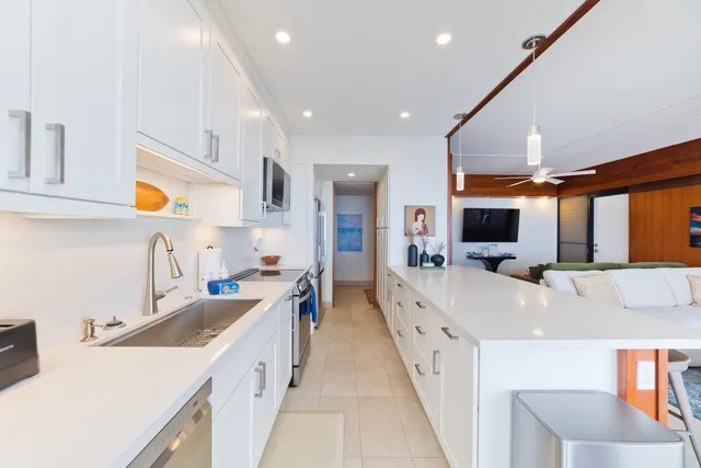 a large white kitchen with a large window