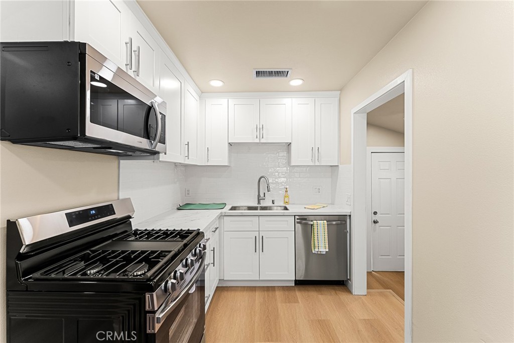 2857 Mulberry Street Riverside, CA 92501 - Photo 8 of 20 a kitchen with stainless steel appliances a sink a stove and microwave