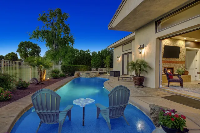 a view of a patio with couches table and chairs and potted plants