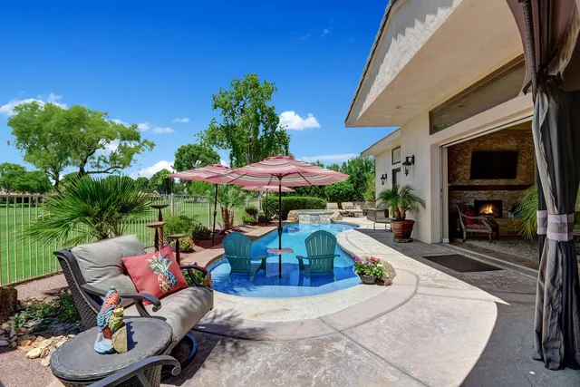 a view of a swimming pool with a patio