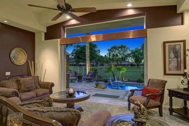 a living room with furniture and a floor to ceiling window