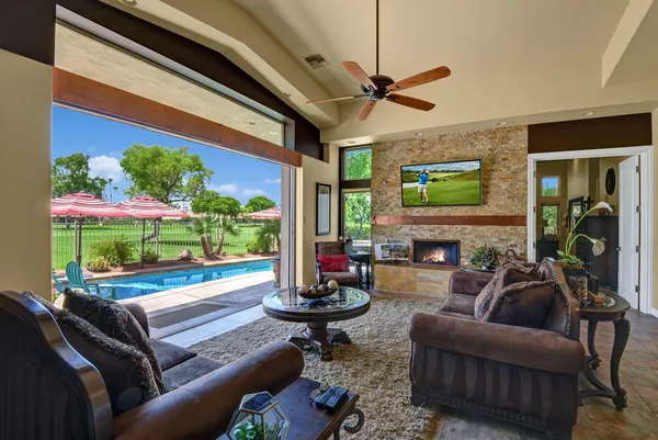 a living room with furniture a fireplace and a flat screen tv