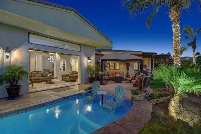 a living room with furniture and potted plants