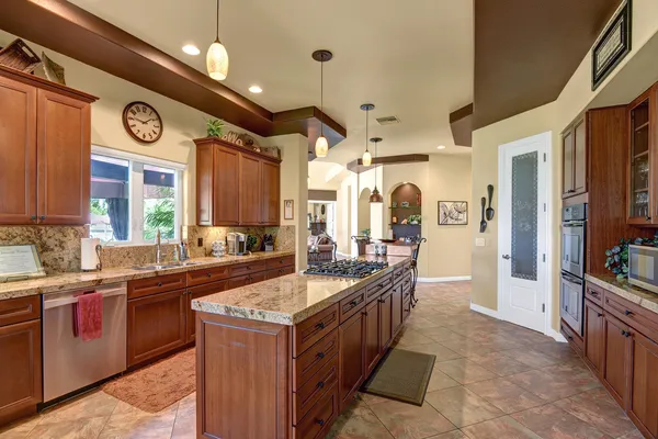 a large kitchen with a table and chairs