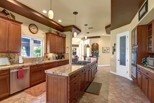 a large kitchen with a lot of counter space and a sink