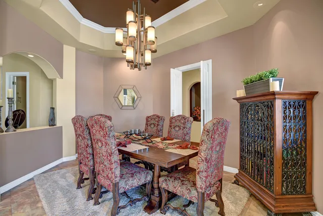 a view of a dining room with furniture and a chandelier