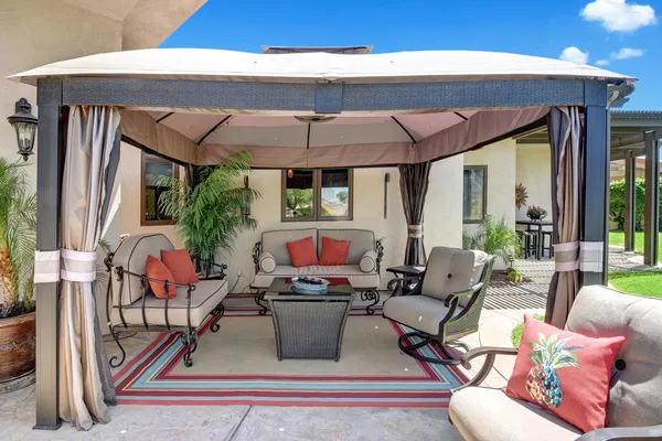 a view of a patio with a table and chairs and potted plants