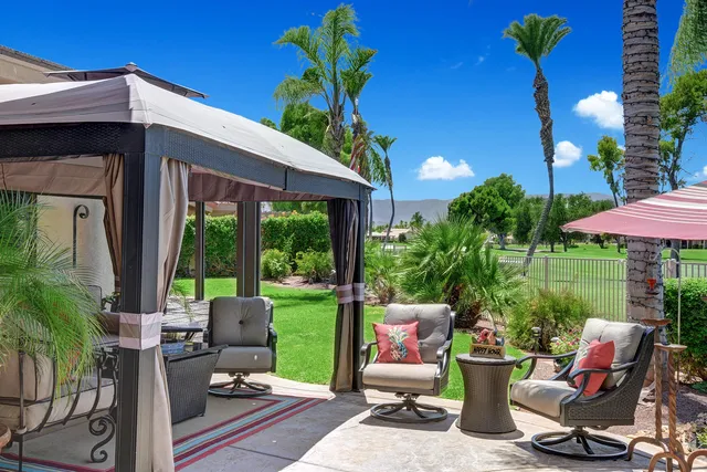 a view of a patio with a table and chairs and potted plants