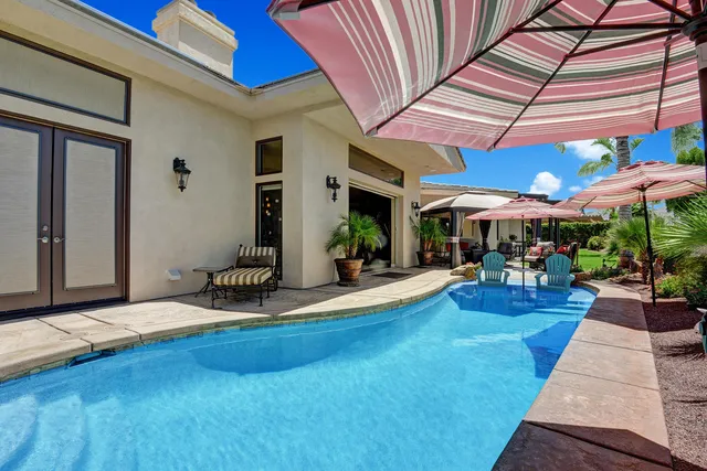 a view of a house with swimming pool and sitting area