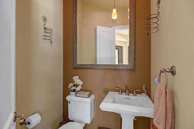 a white toilet sitting next to a bathroom sink