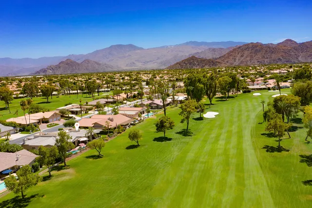 a view of a town with mountains in the background