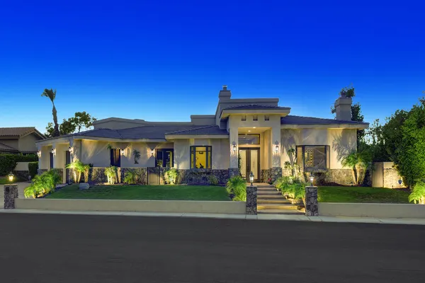 a front view of a house with a garden