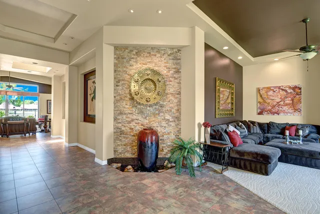 a living room with furniture and a potted plant