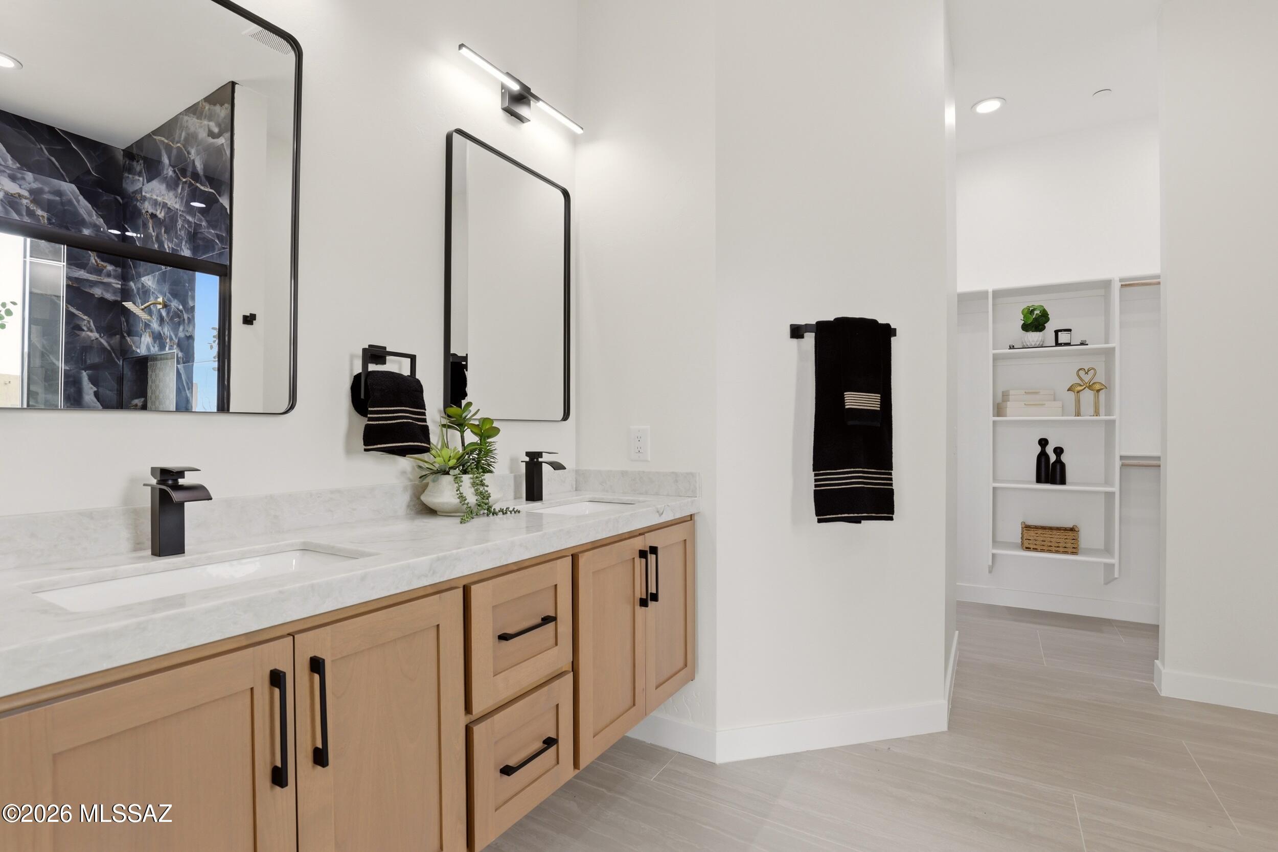14527 East Sands Ranch Road Vail, AZ 85641 - Photo 24 of 48 a bathroom with a double vanity sink and mirror