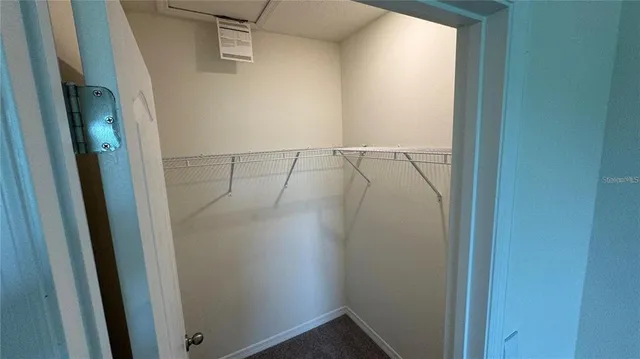 an empty room with closet and wooden floor