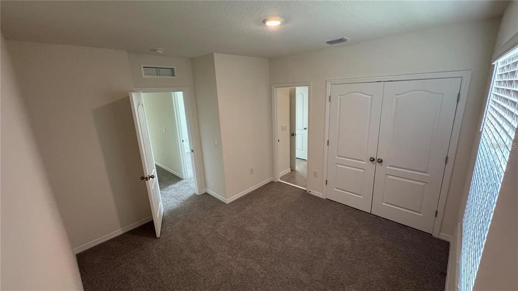 1446 Isleta Loop Kissimmee, FL 34741 - Photo 22 of 27 an empty room with windows
