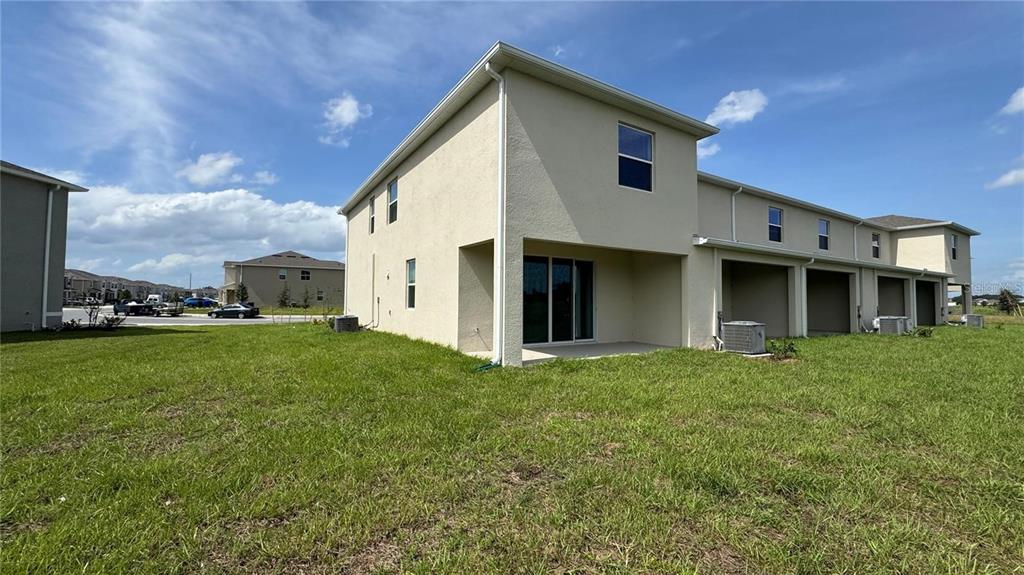 1446 Isleta Loop Kissimmee, FL 34741 - Photo 26 of 27 a front view of a house with a yard