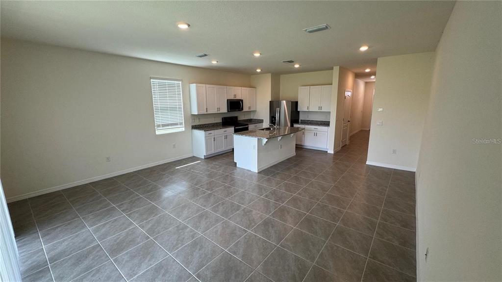 1446 Isleta Loop Kissimmee, FL 34741 - Photo 4 of 27 a view of a kitchen with a sink and microwave