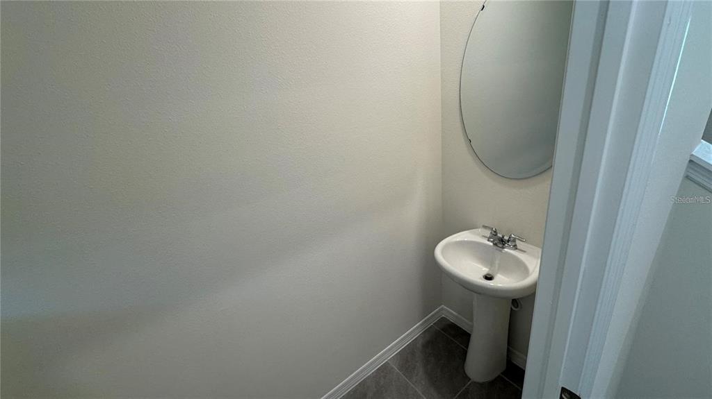 1446 Isleta Loop Kissimmee, FL 34741 - Photo 7 of 27 a bathroom with a sink and toilet