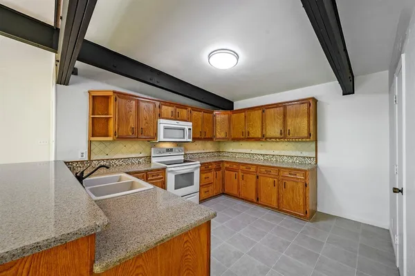 a kitchen with stainless steel appliances granite countertop sink stove and granite counter top