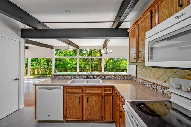 a kitchen with granite countertop a sink and a window