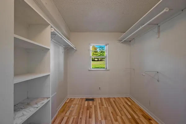a view of room with window and hardwood floor