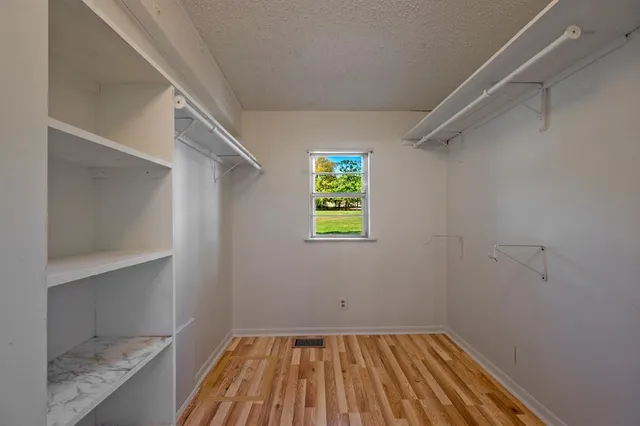 a view of room with window and hardwood floor