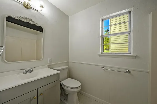 a bathroom with a sink toilet and mirror