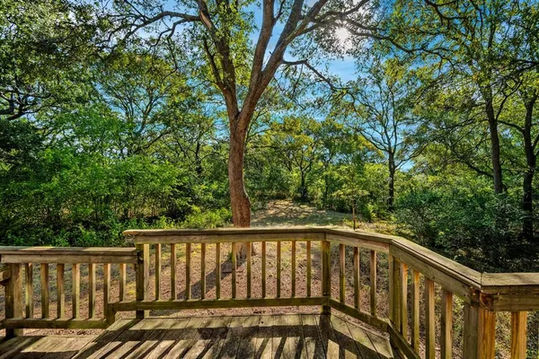a balcony with wooden floor and fence