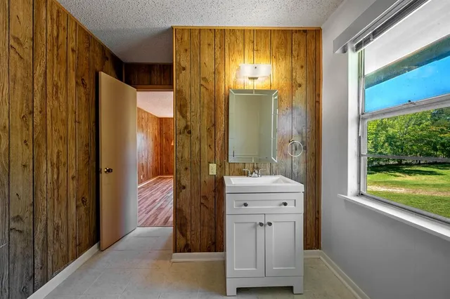 a bathroom with a double vanity sink and mirror
