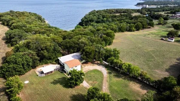 an aerial view of a house with a yard