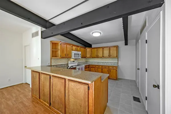 a kitchen with stainless steel appliances granite countertop a sink and a refrigerator