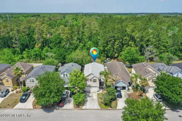 an aerial view of a house with a yard and lake view