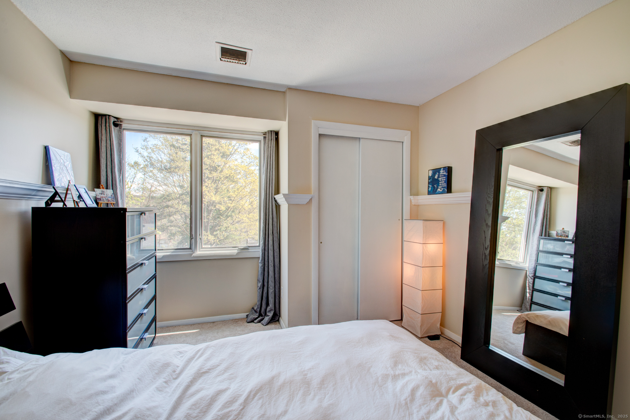 184 Gravel Street, Unit 26 Meriden, CT 06450 - Photo 16 of 27 a bedroom with a bed and large windows