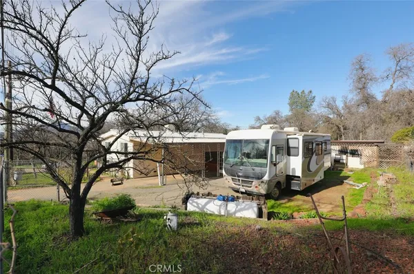 a view of a patio with table and chairs under an umbrella