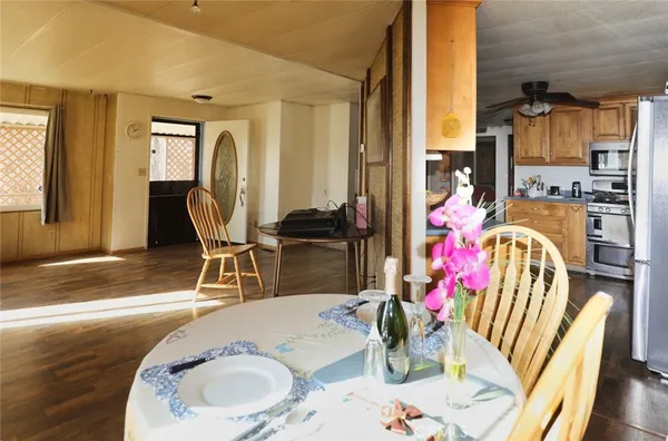 a dining room with furniture and wooden floor