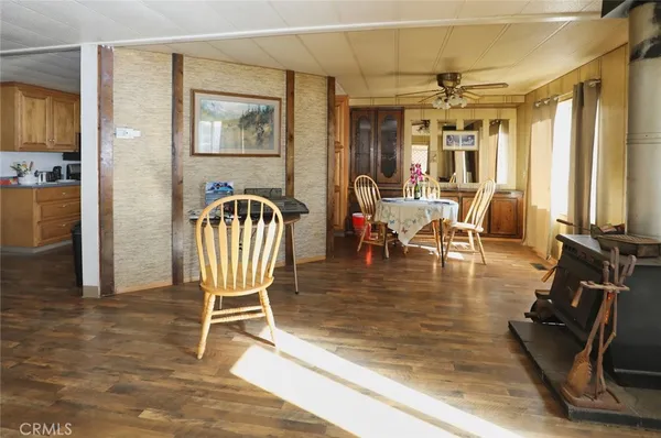 a dining room with furniture a chandelier and wooden floor