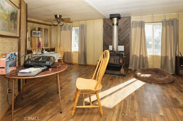 a living room with a couch a table and wooden floor