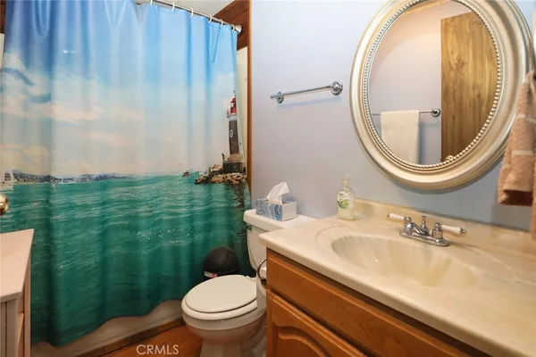 a bathroom with a sink a toilet and a mirror