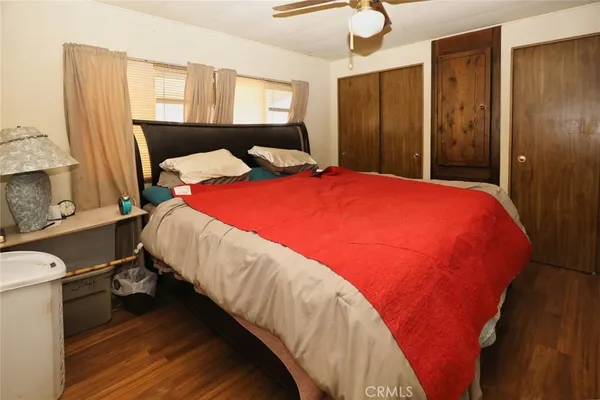 a bed sitting in a bedroom next to a bathroom