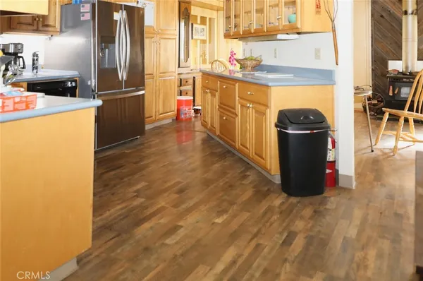 a kitchen with stainless steel appliances granite countertop a refrigerator a stove and a microwave