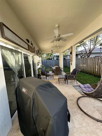a living room with patio furniture and a fireplace
