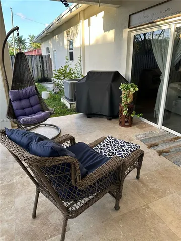 a wooden bench sitting in backside of a house