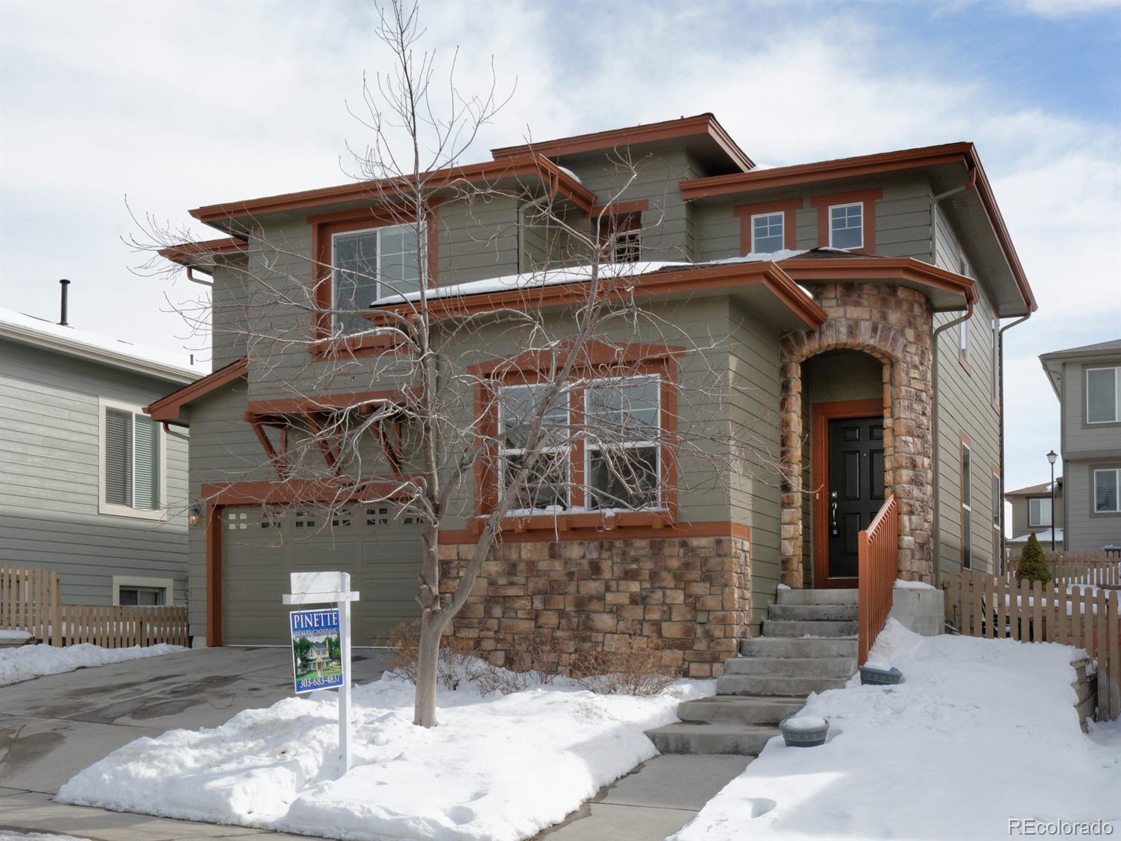 10934 Brooklawn Road Highlands Ranch, CO 80130 - Photo 1 of 1 a front view of a house with a yard